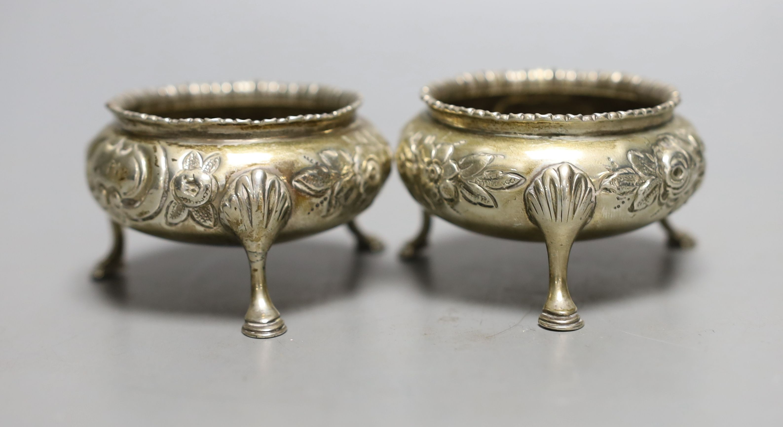 A George III silver cream jug, London, 1806, 10.6cm, a pair of Victorian silver bun salts and four silver napkin rings, 9oz.